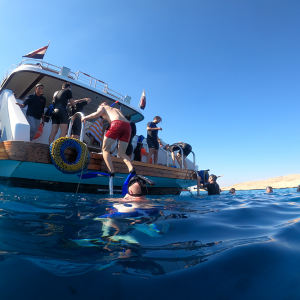 Tourists snorkeling in crystal-clear water